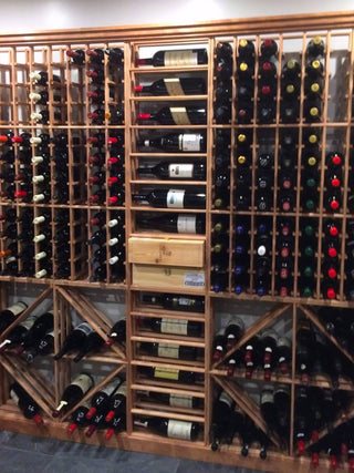 Vintage Keeper Redwood wine racks stacked vertically against a wall in a residential home wine cellar