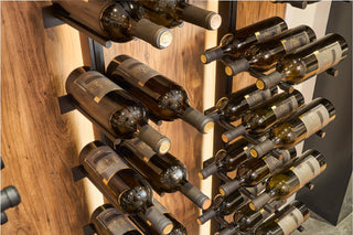 Wine bottles arranged in cork forward and label view orientation on a V Bar floating wine rack.