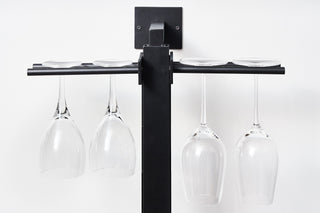 Wine glasses hanging on wine pegs.